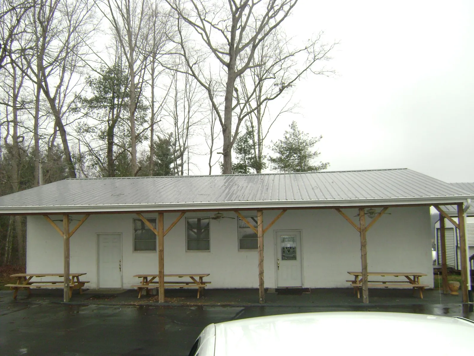 Gray metal roof over a block building with a timber post porch in Richmond
